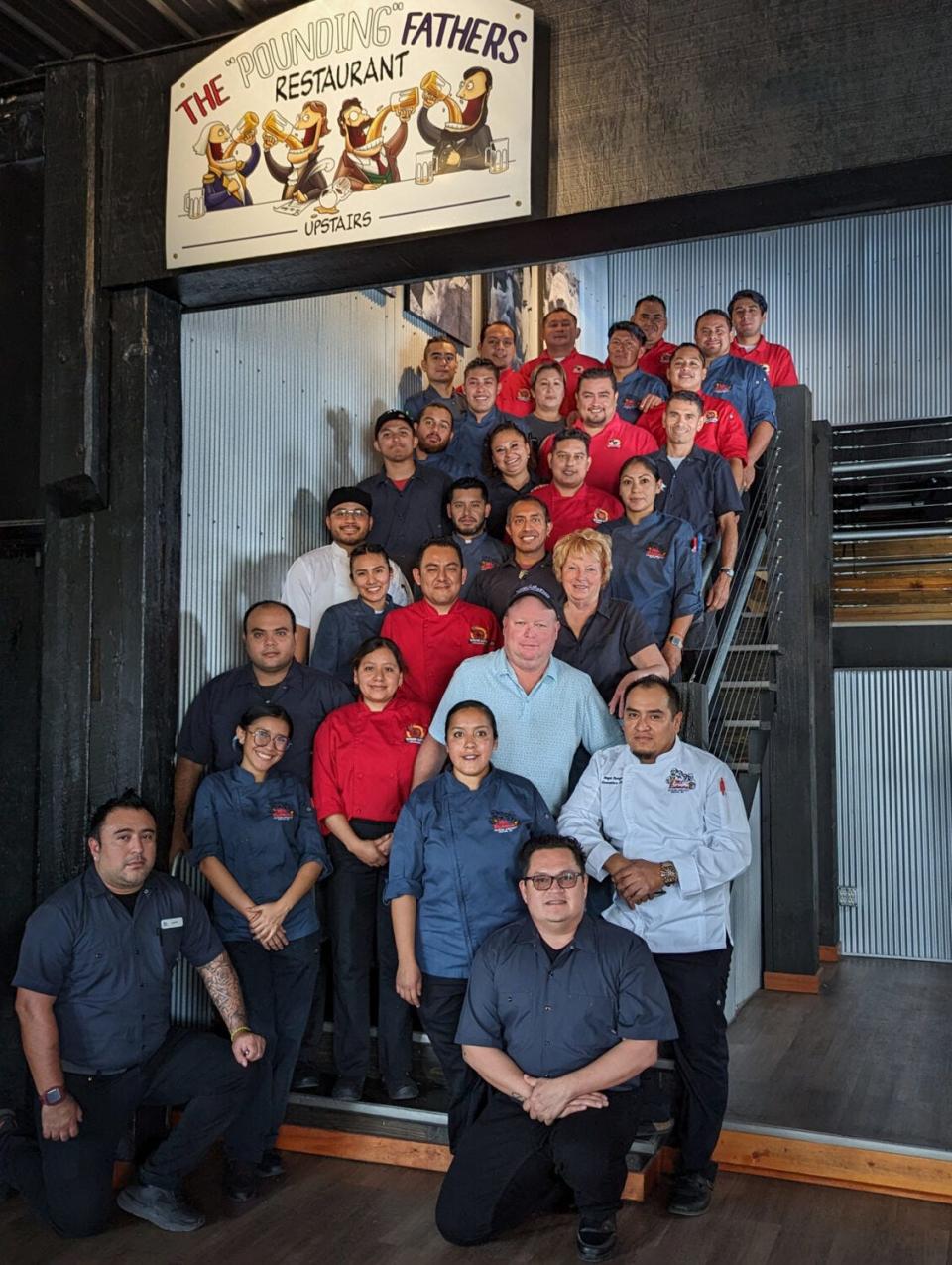 Janet Boyer and her son, Jonathon, owners of the Mt. Rushmore Brewing Company, pose with a group of 29 of their H2-B employees at the Mt. Rushmore Brewing Company/Pounding Fathers Restaurant in Custer.