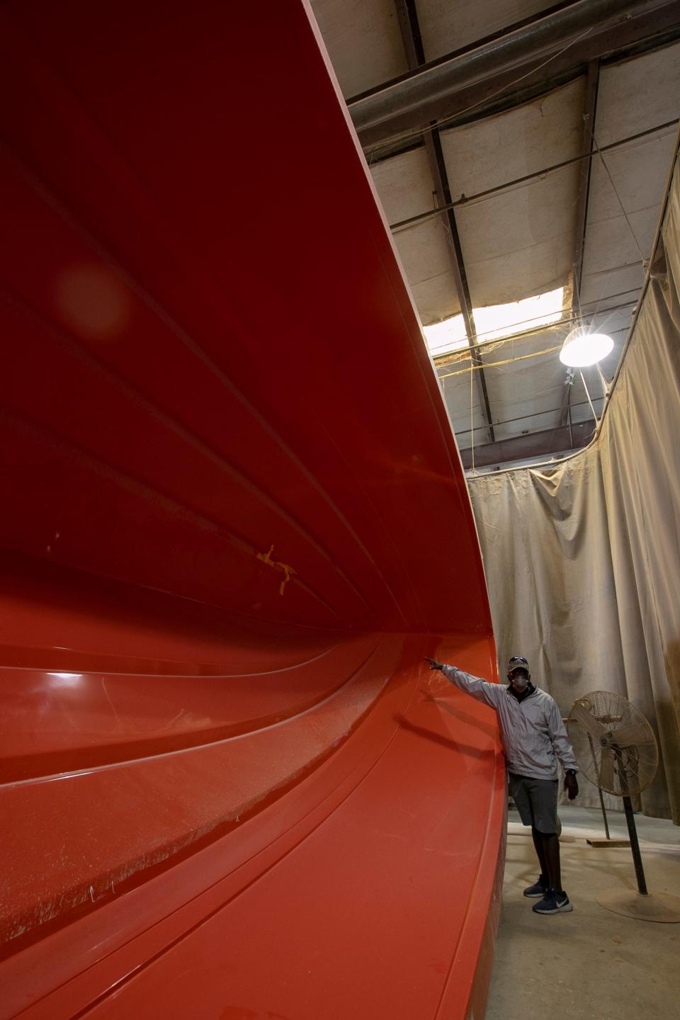 William Mott, plant manager at Marine Concepts, stands by one of the fiberglass plugs currently under production at Marine Concepts.