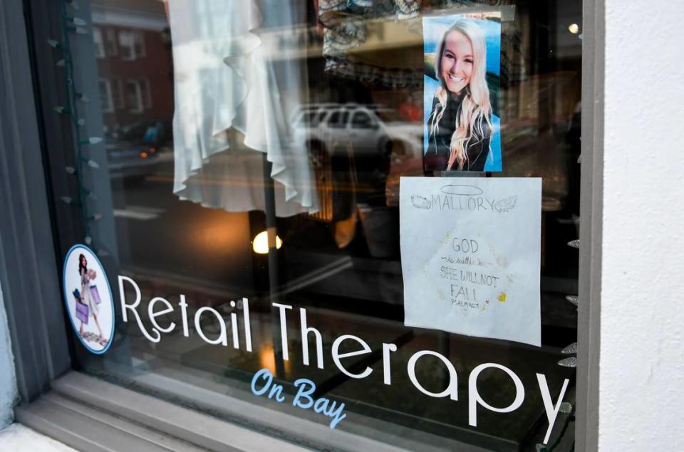 A photo of Mallory Beach and a bible verse are pictured in the window of Retail Therapy on Bay in downtown Beaufort as seen on Friday, Jan. 21, 2020. Mallory, 19, worked at the store before her death when she was killed in a boat accident in Archers Creek in Beaufort County on Feb. 24, 2020 after the boat struck a bridge piling and threw her from the boat.