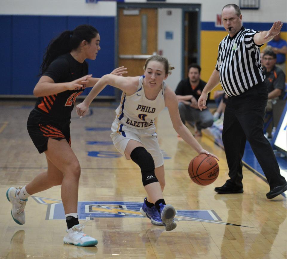 Philo's Olivia Dement tries to dribble past New Lexington's Aubri Spicer during Wednesday's game at The Power Plant. New Lex won 62-38.