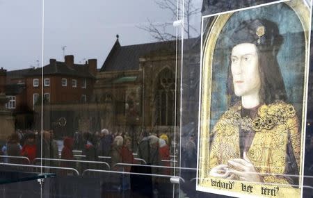 Members of the public are reflected in a shop window as they queue to view the coffin of King Richard III at Leicester Cathedral, central England, March 25, 2015. REUTERS/Darren Staples
