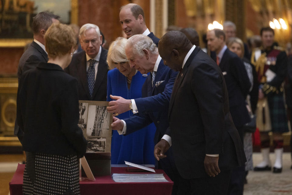 Britain's King Charles III, Camilla, the Queen Consort and President Cyril Ramaphosa of South Africa, right, view a display of South African items from the Royal Collection at Buckingham Palace, London, Tuesday Nov. 22, 2022, during the two day state visit to the UK by the South African president. (Dan Kitwood/Pool via AP)