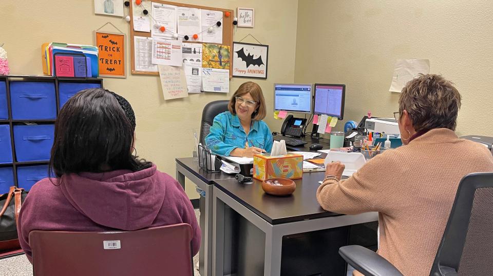 Case managers Nora Medina (middle) and Nancy Jackabon (right) work with a client at Turning Points in Bradenton. Turning Points offers a unique array of free programs to help people and families achieve financial stability and independence.