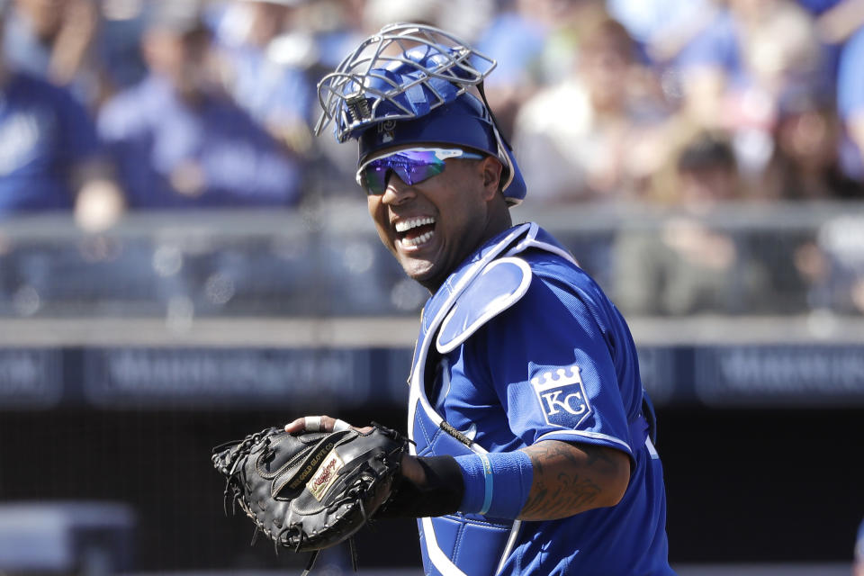FILE - In this Wednesday, March 4, 2020, file photo, Kansas City Royals catcher Salvador Perez smiles as he turns to a teammate who made an out on a difficult play against the San Diego Padres in the first inning during a spring training baseball game in Peoria, Ariz. (AP Photo/Elaine Thompson, File)