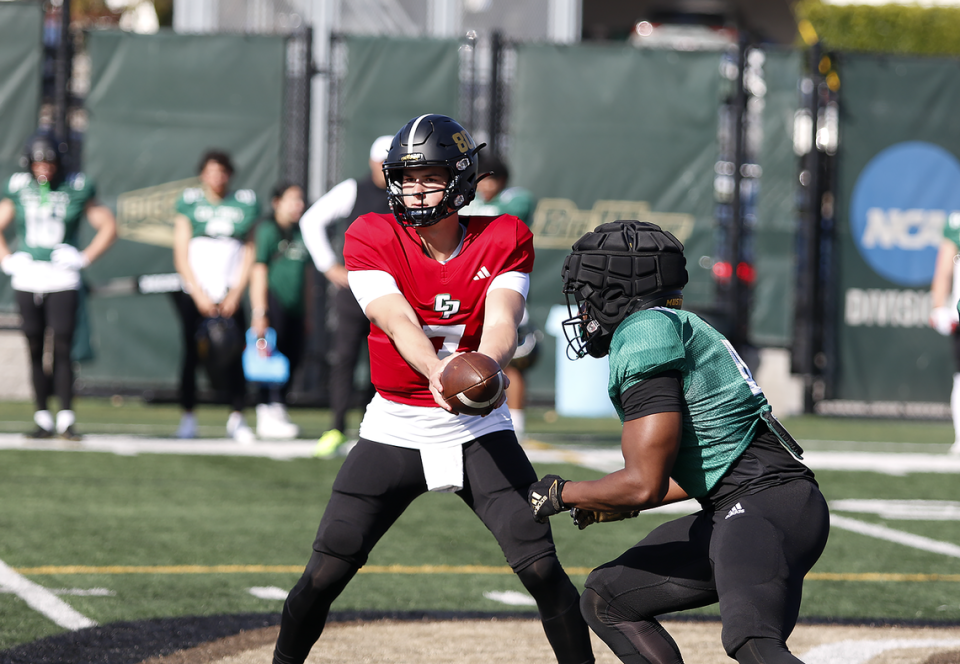 Mustang quarterback Sam Huard (7) hands the ball to Mark Biggins (4) during the Cal Poly football team’s spring practices at Doerr Family Field on April 14, 2023.