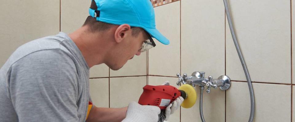 Man polishing bathroom faucet.