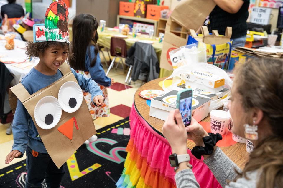 Pre-k student teacher Madelyn Burton takes a photo of Marocco Edwards in a turkey outfit during Friendsgiving at Sam Houston Elementary on Thursday, Nov. 16, 2023, in Corpus Christi, Texas.