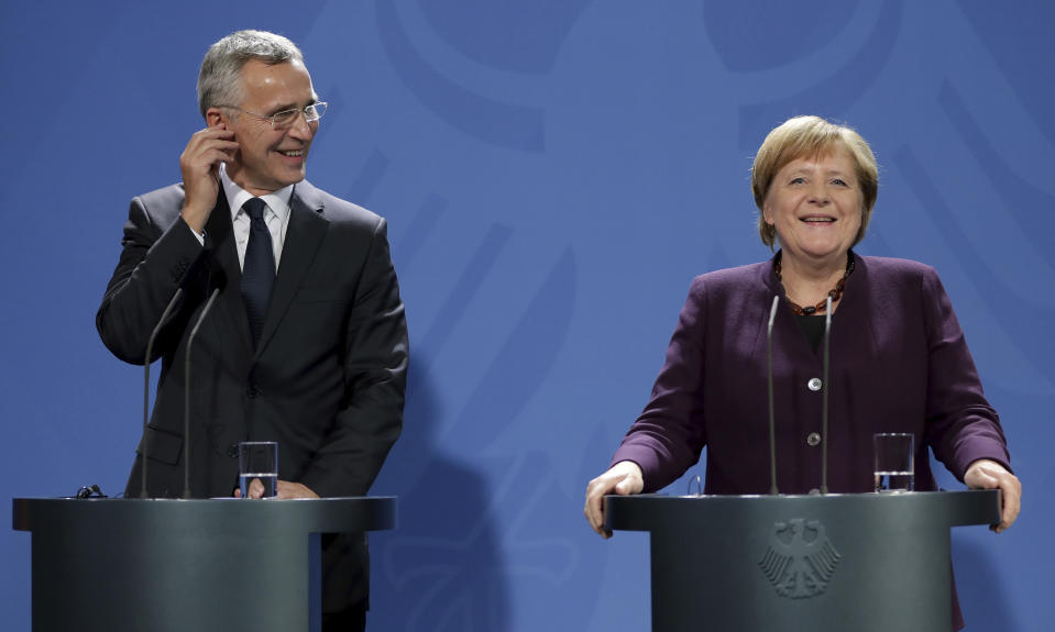 German Chancellor Angela Merkel, right, and NATO Secretary General Jens Stoltenberg, left, address the media during a press conference at the Chancellery in Berlin, Germany, Thursday, Nov. 7, 2019. (AP Photo/Michael Sohn)