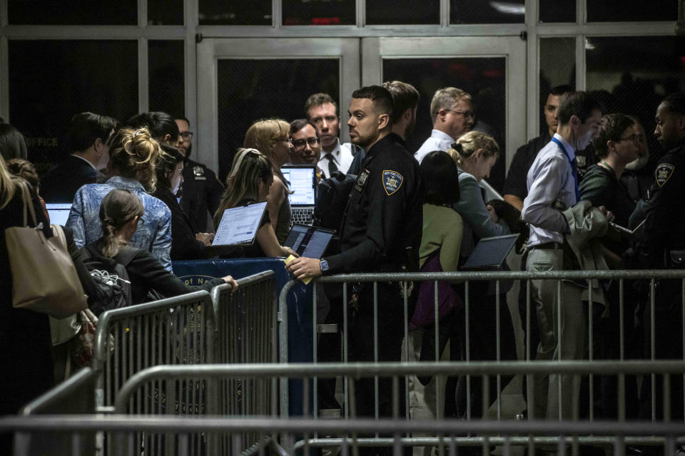 Reporters return to the courtroom after being made to briefly leave during the ongoing trial of former President Donald Trump at Manhattan Criminal Court, Monday, May 20, 2024 in New York. Trump is charged with falsifying 34 business records in an attempt to cover up a payment to adult film actress Stormy Daniels. (Pool photo by Dave Sanders for The New York Times)