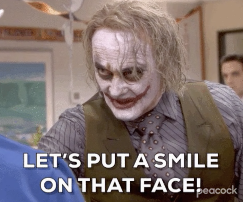 Creed dressed as the Joker on the office saying, "Let's put a smile on that face!"