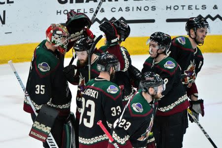 Feb 16, 2019; Glendale, AZ, USA; Arizona Coyotes goaltender Darcy Kuemper (35) celebrates with teammates after beating the Toronto Maple Leafs 2-0 at Gila River Arena. Mandatory Credit: Matt Kartozian-USA TODAY Sports