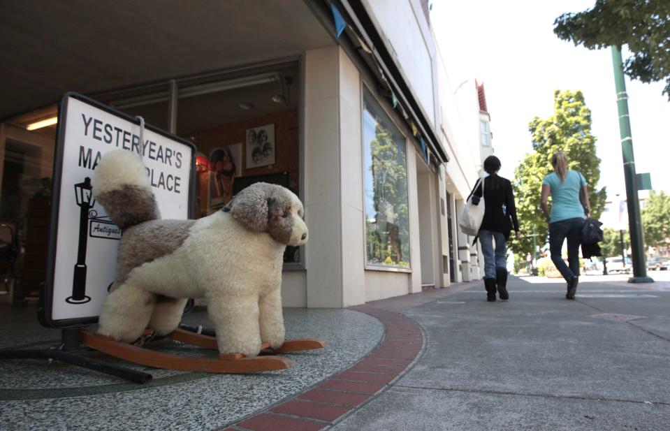 In this photo taken Thursday, July 19, 2012, a stuffed toy dog is seen outside an antique store on Georgia St. in downtown Vallejo, Calif. After the 1996 closure of the Mare Island Naval Shipyard, the area's largest employer, the burst of the housing bubble, and the downturn in the economy, Vallejo declared bankruptcy in 2008. The city emerged from bankruptcy last year and offers an example for what can come, both good and bad, from the experience. Some in the community say bankruptcy was the city's only option to climb out of a financial hole while others say more could have been done to avoid it.(AP Photo/Rich Pedroncelli)