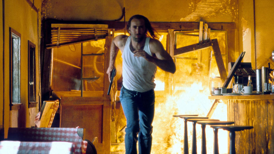 Nicolas Cage running through a burning building in a scene from the film 'Con Air', 1997. (Photo by Touchstone Pictures/Getty Images)