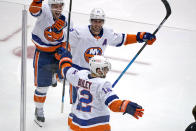 New York Islanders' Josh Bailey (12) celebrates his winning overtime goal in Game 5 of an NHL hockey Stanley Cup first-round playoff series against the Pittsburgh Penguins in Pittsburgh, Monday, May 24, 2021. (AP Photo/Gene J. Puskar)
