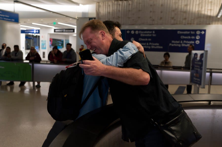 Michael White, a Navy veteran who was jailed in Iran for several years on spying charges, right, hugs Michael’s former fellow prisoner and Iranian political activist Mahdi Vatankhah at the Los Angeles International Airport in Los Angeles, Thursday, June 1, 2023. Vatankhah, while in custody and after his release, helped White by providing White’s mother with crucial, firsthand accounts about her son’s status in prison and by passing along letters White had written while he was locked up. Once freed, White did not forget. He pushed successfully this year for Vatankhah’s admission to the United States, allowing the men to be reunited last spring, something neither could have envisioned when they first met in prison years earlier. (AP Photo/Jae C. Hong)