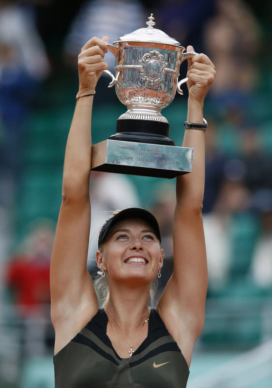 Russia's Maria Sharapova holds a trophy after winning over Italy's Sara Errani during their Women's Singles final tennis match of the French Open tennis tournament at the Roland Garros stadium, on June 9, 2012 in Paris. AFP PHOTO / PATRICK KOVARIKPATRICK KOVARIK/AFP/GettyImages