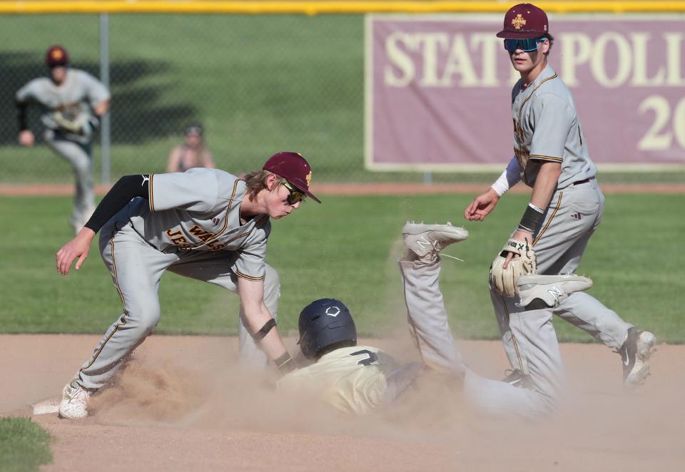 Hoban baserunner Leo Wilson is tagged out as he attempts to steal second by Walsh Jesuit shortstop Matthew Mansberry as second baseman Jagger Dalton backs up the play May 2 in Cuyahoga Falls.