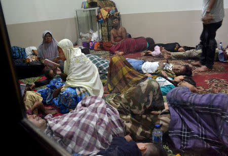 Residents sit inside a mosque as they evacuated following high waves and the eruption of Anak Krakatau volcano at Labuan district in Pandeglang regency, Banten province, Indonesia, December 22, 2018 in this photo taken by Antara Foto. Picture taken December 22, 2018. Antara Foto/Muhammad Bagus Khoirunas/ via REUTERS