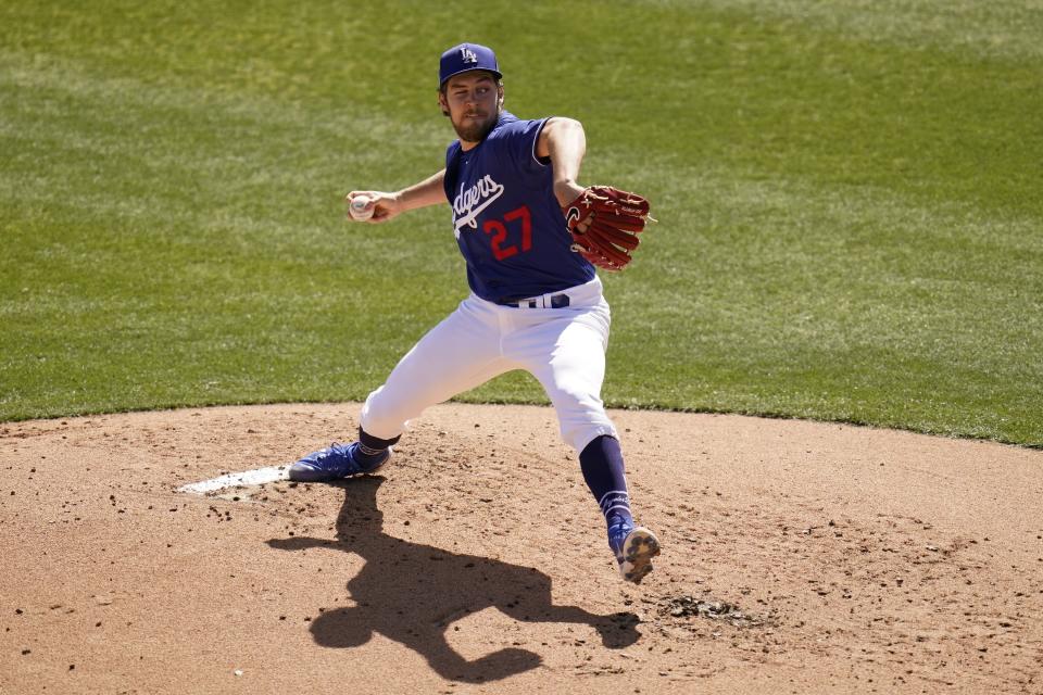 Pitching with one eye closed, Los Angeles Dodgers starting pitcher Trevor Bauer throws a pitch against the San Diego Padres during the second inning of a spring training baseball game Saturday, March 6, 2021, in Phoenix. (AP Photo/Ross D. Franklin)