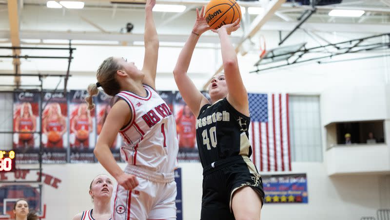 Springville’s Ellie Esplin (1) jumps to block a shot from Wasatch’s Emlia Brown (40) during a high school girls basketball game at Springville High School in Springville on Friday, Feb. 10, 2023.