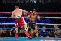 May 7, 2016; Las Vegas, NV, USA; Amir Khan (maroon shorts) dodges a punch from Canelo Alvarez (red shorts) during their middleweight boxing title fight at T-Mobile Arena. Mandatory Credit: Joshua Dahl-USA TODAY Sports