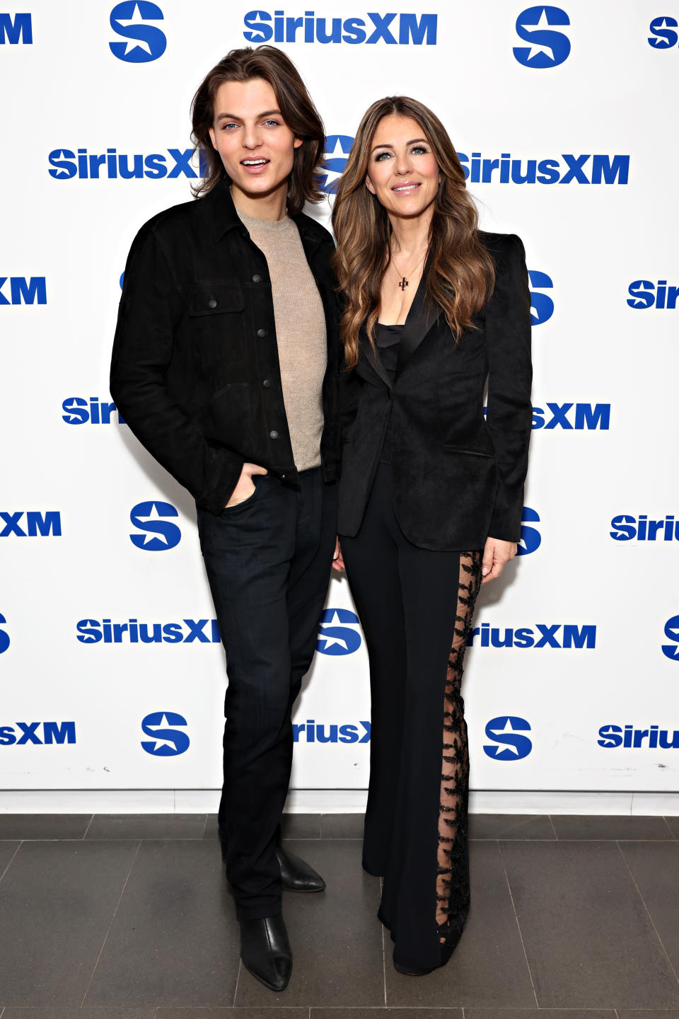 Damian Hurley wears all-black shoes with mother at SiriusXM