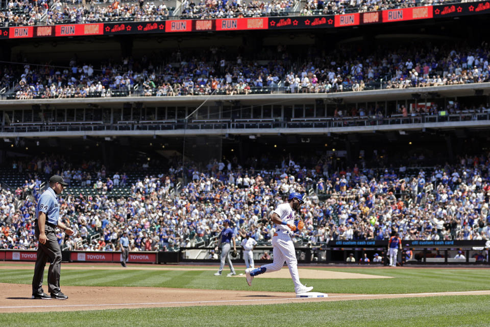 New York Mets' Starling Marte, front right, rounds third base after hitting a home run off of Texas Rangers pitcher Jon Gray during the first inning of a baseball game on Sunday, July 3, 2022, in New York. (AP Photo/Adam Hunger)