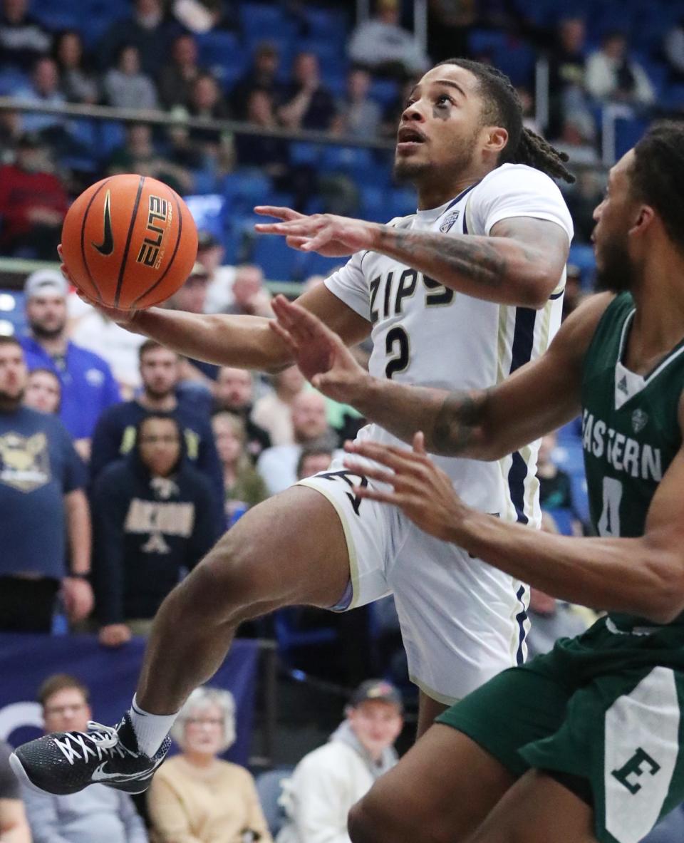 Akron's Greg Tribble goes to the basket as Eastern Michigan's Jalin Billingsley defends during their MAC game at the University of Akron's James A. Rhodes Arena on Friday. The Zips beat the Eagles 104 to 67.