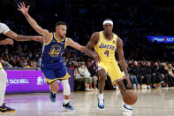 Golden State Warriors guard Stephen Curry (30) defends against Los Angeles Lakers guard Rajon Rondo (4) during the first half of an NBA basketball game in Los Angeles, Tuesday, Oct. 19, 2021. (AP Photo/Ringo H.W. Chiu)