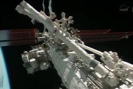 Flight engineers Michael Hopkins and Richard Mastracchio perform a series of spacewalks outside the International Space Station (ISS) in this December 21, 2013 still image taken from a NASA handout video. REUTERS/NASA/Handout via Reuters