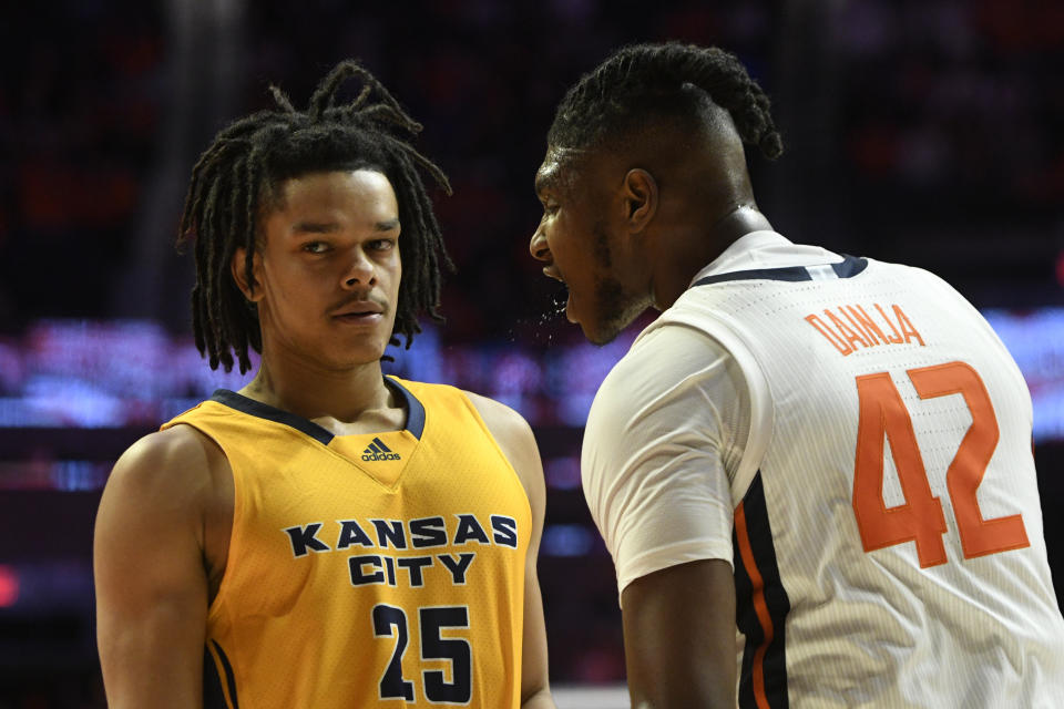 Illinois' Dain Dainja (42) gets in the face of Kansas City's Tyler Andrews after a shot by Kansas City's RayQuawndis Mitchell was blocked during the second half of an NCAA college basketball game Friday, Nov. 11, 2022, in Champaign, Ill. (AP Photo/Michael Allio)