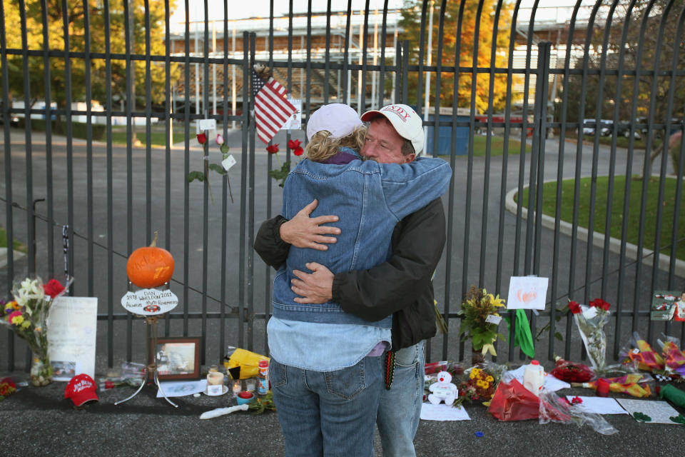 INDIANAPOLIS, IN - OCTOBER 17: Bob Herring and his wife Cindy embrace at the gate to the Indianapolis Motor Speedway where tributes were being left by race fans at a memorial to two-time Indianapolis 500 winner Dan Wheldon on October 17, 2011 in Indianapolis, Indiana. Wheldon was killed in a crash yesterday at the Izod IndyCar series season finale at Las Vegas Motor Speedway. (Photo by Scott Olson/Getty Images)