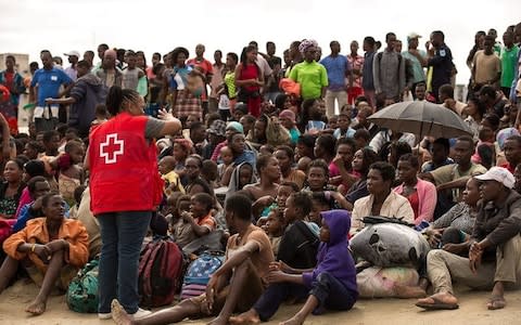 Survivors listen to a volunteer from Mozambique Red Cross, after arriving at an evacuation centre  - Credit: &nbsp;REUTERS