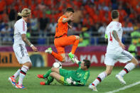 KHARKOV, UKRAINE - JUNE 09: Klaas Jan Huntelaar of Netherlands tries to chip the ball over goalkeeper Stephan Andersen of Denmark during the UEFA EURO 2012 group B match between Netherlands and Denmark at Metalist Stadium on June 9, 2012 in Kharkov, Ukraine. (Photo by Julian Finney/Getty Images)