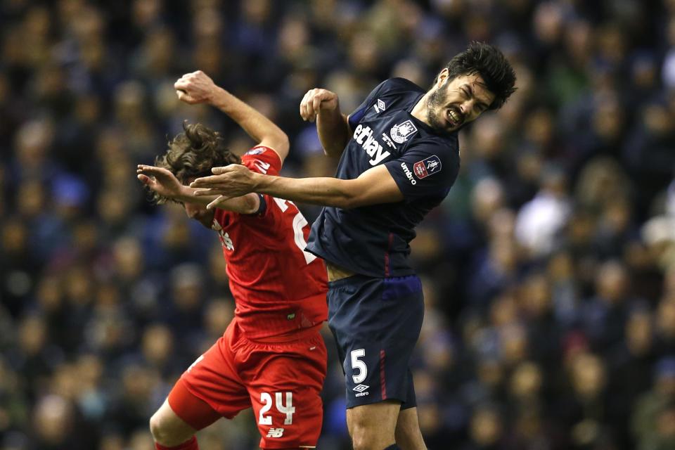 Football Soccer - Liverpool v West Ham United - FA Cup Fourth Round - Anfield - 30/1/16 West Ham's James Tomkins in action with Liverpool's Joe Allen Reuters / Phil Noble Livepic EDITORIAL USE ONLY. No use with unauthorized audio, video, data, fixture lists, club/league logos or "live" services. Online in-match use limited to 45 images, no video emulation. No use in betting, games or single club/league/player publications. Please contact your account representative for further details.