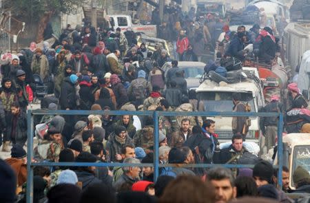 Rebel fighters and civilians gather as they wait to be evacuated from a rebel-held sector of eastern Aleppo, Syria December 16, 2016. REUTERS/Abdalrhman Ismail