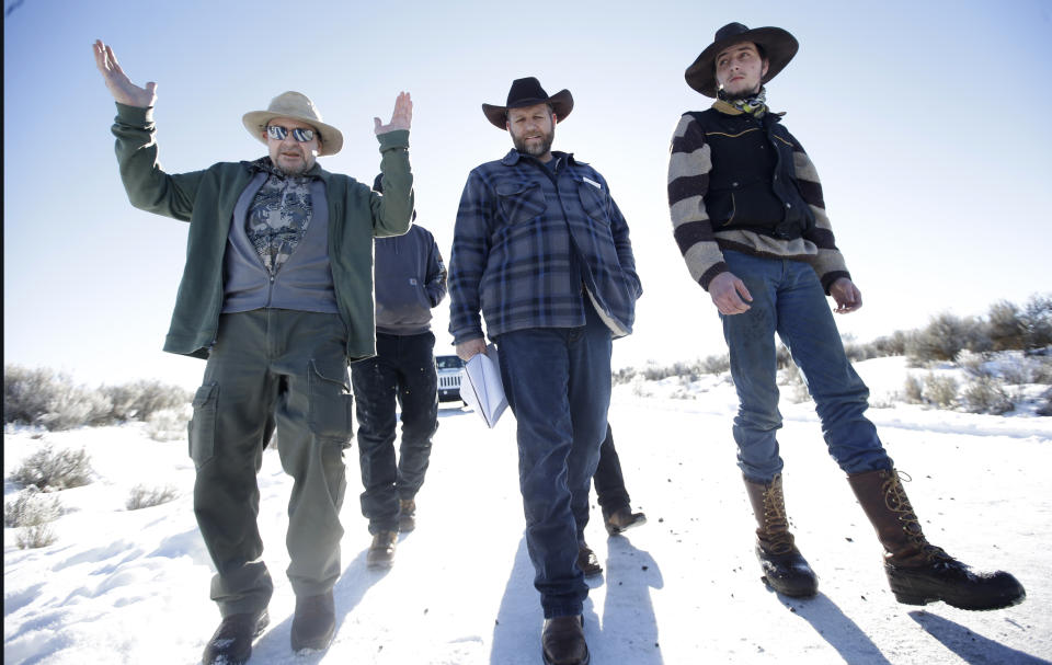 FILE - In this Jan 8, 2016, file photo, Burns resident Steve Atkins, left, talks with Ammon Bundy, center, one of the sons of Nevada rancher Cliven Bundy, following a news conference at Malheur National Wildlife Refuge near Burns, Ore. Cliven and his sons Ryan and Ammon have engaged in armed standoffs with the federal government, first in a fight over grazing permits on federal land in Nevada in 2014, and then in a 40-day occupation of the Malheur Wildlife Refuge in Oregon in 2016. Those standoffs drew the sympathies of some Western ranchers and farmers who feared they were losing the ability to prosper financially. (AP Photo/Rick Bowmer, File)