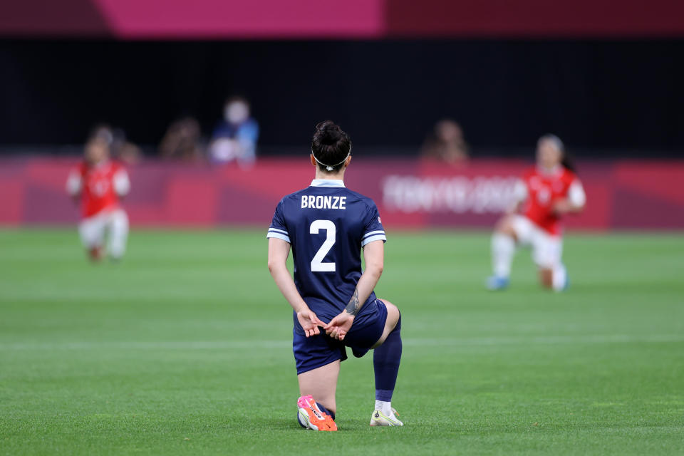 Jugadoras británicas y chilenas se arrodillan previo al inicio del partido con Chile en los Juegos Olímpicos de Tokio.