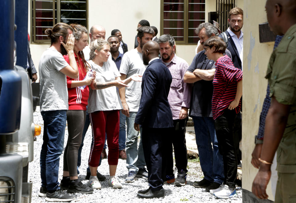 Eight Croatian nationals charged with attempting to traffic children, outside the magistrates court in Ndola, Zambia, Tuesday, Jan. 10, 2023. The 8 have pleaded not guilty to the charge of child trafficking before a magistrate. (AP Photo/Salim Dawood)