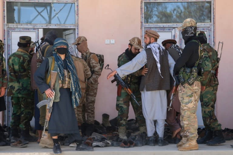 Armed Taliban security personnel frisk people at the entrance of a mosque in Argo district, Badakhshan province (OMER ABRAR)