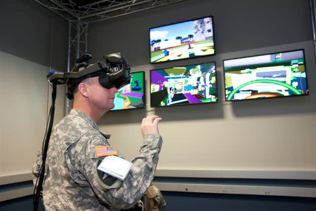 A soldier works with VR goggles.