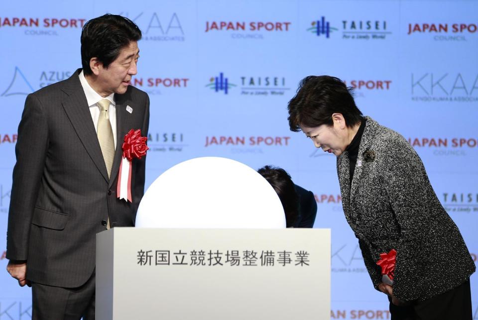 Japanese Prime Minister Shinzo Abe, left, is greeted by Tokyo Gov. Yuriko Koike after a groundbreaking ceremony of new national stadium in Tokyo, Sunday, Dec. 11, 2016. Tokyo held the ceremony on Sunday for a $1.5 billion National Stadium to host the 2020 Olympic Games. (AP Photo/Shizuo Kambayashi)