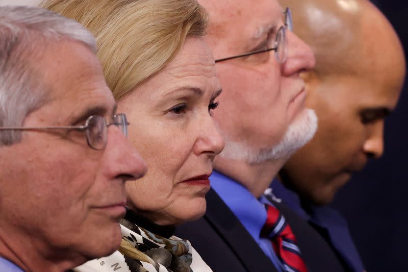 FILE PHOTO: White House coronavirus task force members Fauci, Birx, Redfield and Adams listen to Trump during the daily coronavirus briefing at the White House in Washington