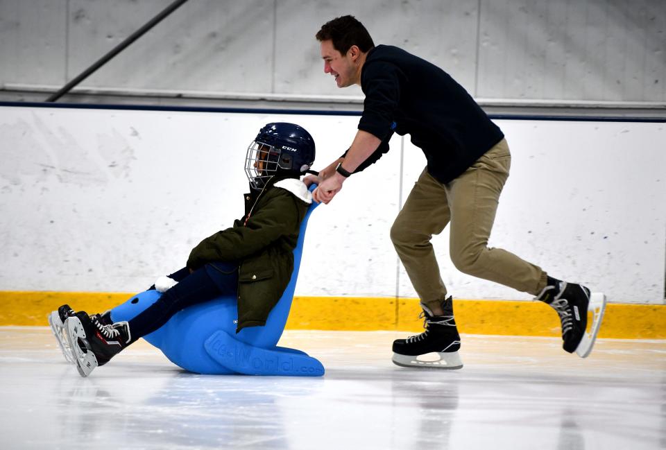 City View Elementary School teacher Drew Burchill pushes fourth grader Aubrielle Barber around the rink Tuesday as Worcester Railers host Skate to Success program at the Worcester Ice Center.