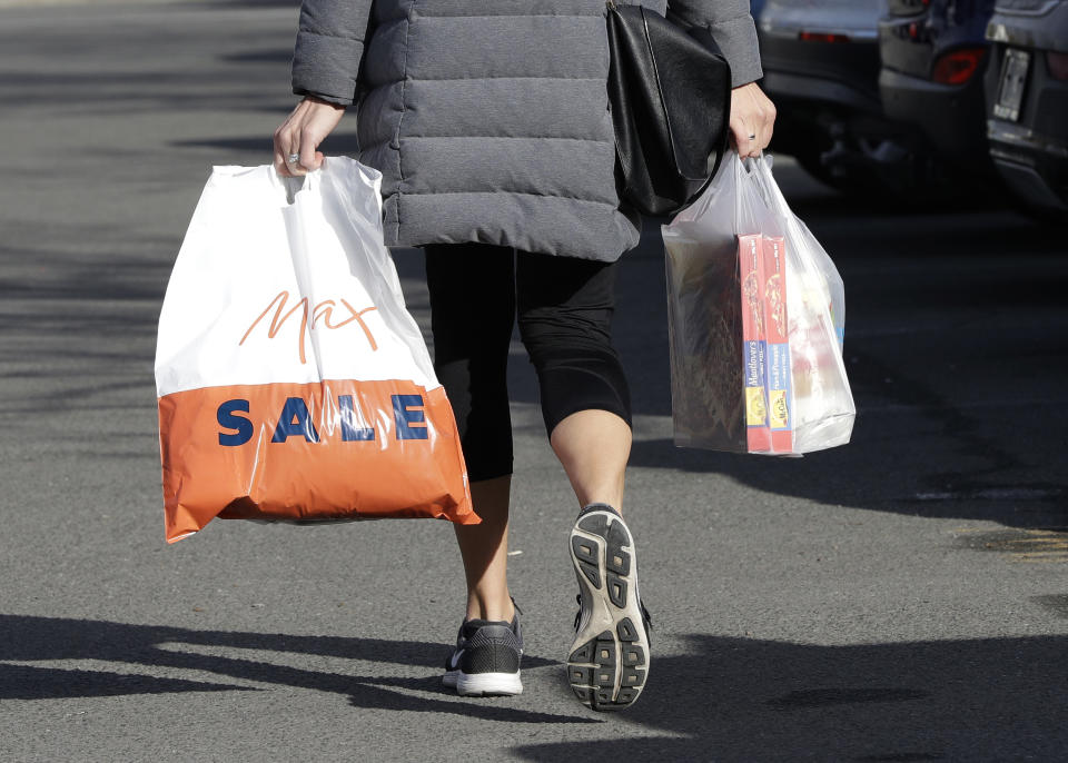 A shopper leaves a supermarket with goods in plastic bags in Christchurch, New Zealand, Friday, Aug. 10, 2018. New Zealand plans to ban disposable plastic shopping bags by next July as the nation tries to live up to its clean-and-green image. Prime Minister Jacinda Ardern said Friday that New Zealanders use hundreds of millions of the bags each year and that some of them end up polluting the precious coastal and marine environment. (AP Photo/Mark Baker)