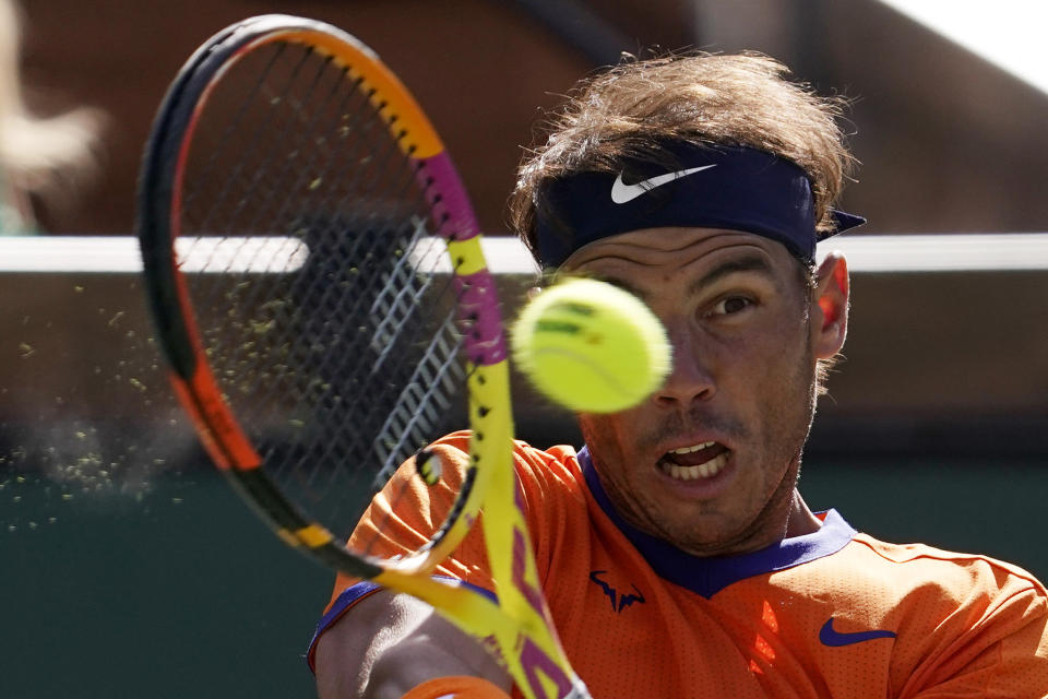 FILE - Rafael Nadal, of Spain, returns a shot to Taylor Fritz during the men's singles finals at the BNP Paribas Open tennis tournament Sunday, March 20, 2022, in Indian Wells, Calif. Nadal will compete in the U.S. Open tennis tournament that begins Monday. (AP Photo/Mark J. Terrill, File)