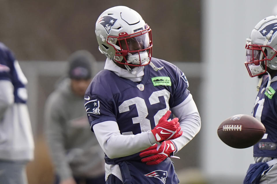 New England Patriots safety Devin McCourty (32) tosses the ball while warming up during an NFL football practice, Tuesday, Dec. 6 2022, in Foxborough, Mass. (AP Photo/Steven Senne)