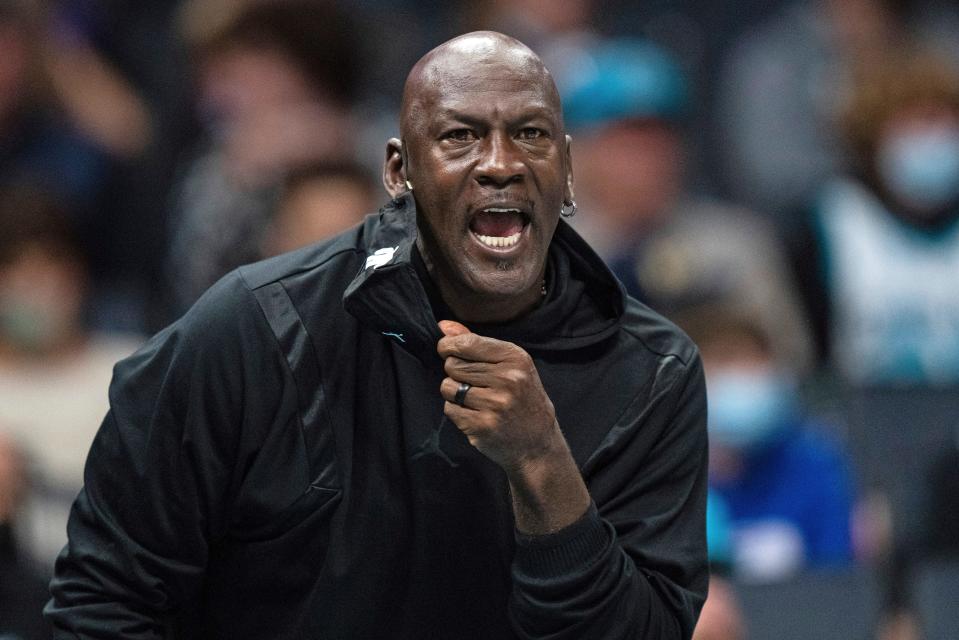 Michael Jordan looks on during the first half of an NBA basketball game between the Charlotte Hornets and the New York Knicks in Charlotte, N.C., Friday, Nov. 12, 2021. (AP Photo/Jacob Kupferman)