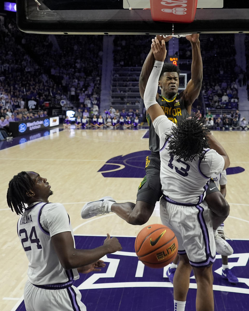 Baylor center Yves Missi gets past Kansas State forward Will McNair Jr. (13) to dunk the ball during the first half of an NCAA college basketball game Tuesday, Jan. 16, 2024, in Manhattan, Kan. (AP Photo/Charlie Riedel)