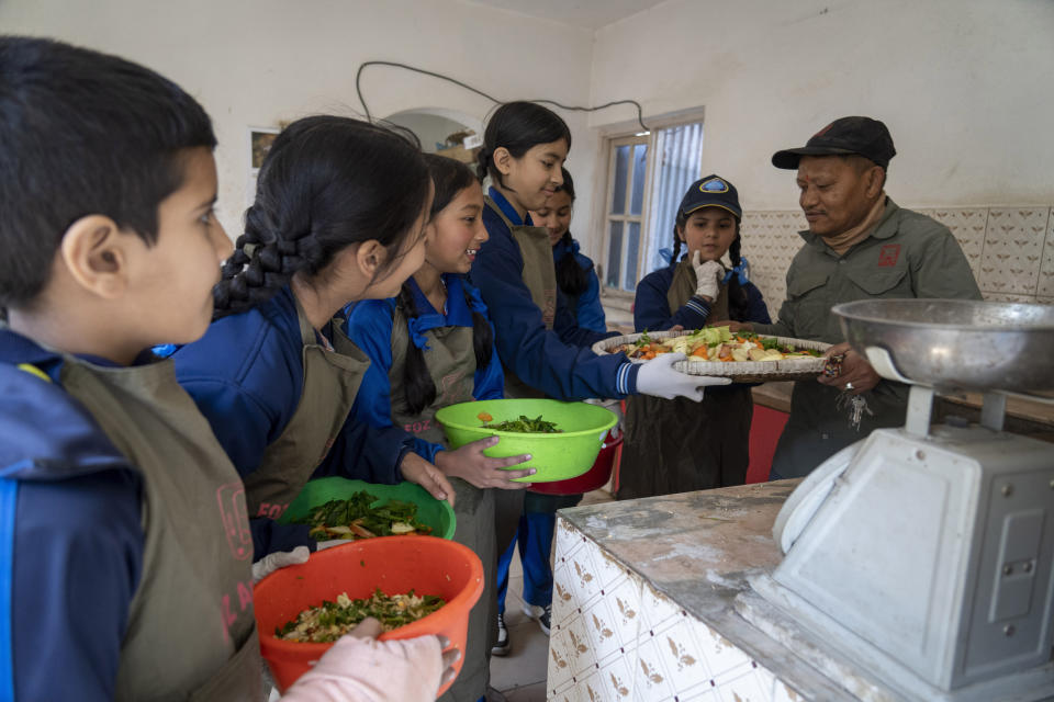 Students receive food from a zoo keeper to feed animals at Nepal’s Central Zoo in Lalitpur, Nepal, on Feb. 23, 2024. The only zoo in Nepal is home to more than 1,100 animals of 114 species, including the Bengal Tiger, Snow Leopard, Red Panda, One-Horned Rhino and the Asian Elephant. (AP Photo/Niranjan Shrestha)